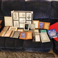 Full group of assorted frames arranged on sofa