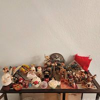 Overall view of assorted figurines and souvenirs on glass cabinet