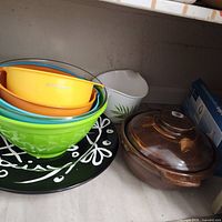 KitchenAid nesting bowls, casserole with lid, white container, boxed item on pantry shelf