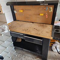 Front view of Craftsman workbench showing pegboard, light canopy and work surface