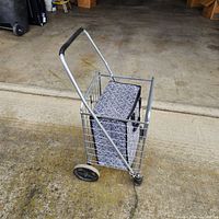 Full view of folded metal cart with bag inside