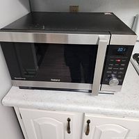 Front view of Galanz SpeedWave stainless steel countertop microwave oven on counter