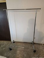 Full view of chrome garment rack with casters