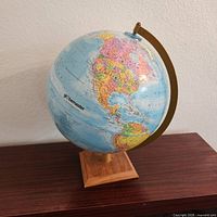 Full view of Globemaster globe on wood base
