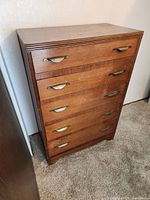 Front view of dresser showing five drawers and metal pulls