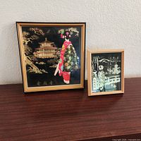 Both framed artworks on surface