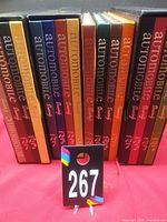 Front view of 16 Automobile Quarterly hardcover books in slipcases showing spines and volume numbers