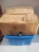 Closed cardboard shipping case on plastic tote