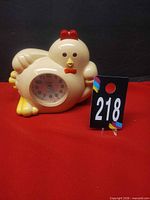Front view of chicken-shaped alarm clock showing dial and overall design