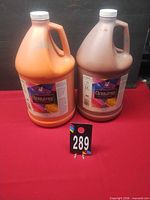 Front view of both one-gallon paint jugs showing colors and labels