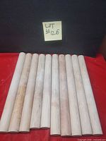 10 wooden rolling dowels laid out side by side