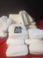 Stacked rolls of white disposable shoe covers with lot number card