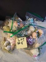 Group of all zip bags labelled Lot #8 containing various faux floral accessories
