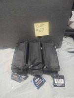 Three black Hilroy pencil cases with tags front view
