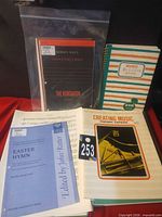Front view showing multiple titles including Creating Music Theory Papers, Kontakion, Easter Hymn, manuscript notebook