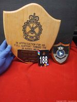 Front view of both plaques showing inscriptions and crest