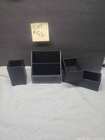 group shot of the four black faux leather desk organizers