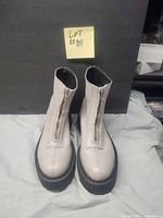 Top view of both boots showing front zippers and platform soles