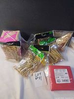 Group shot showing all sealed packs of bamboo skewers, box of straws, pack of napkins