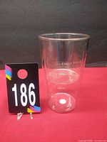 Full view of clear double-wall cup standing upright showing inner chamber and "(HALF FULL)" text