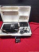 Camera, flash and charger arranged in original foam box