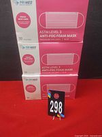 Front view of three sealed boxes showing product name, ASTM level, anti-fog feature and box count