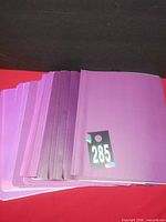 Stack of purple report covers numbered 285