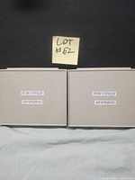 Two closed grey specimen slide storage boxes showing exterior labels
