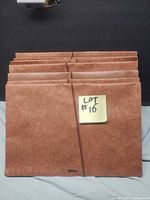 Front view of seven brown Staples expanding file folders
