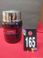 Front view of black Thermos food jar with stainless lid
