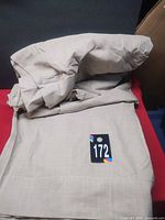 Folded beige curtains showing fabric texture and overall color