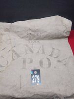 Overall view showing CANADA P.O. stencil and 1955 date on canvas bag