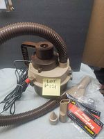 overall view of vacuum, hose, power cord, two nozzle attachments and packaged filters