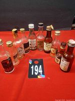Group of ten empty miniature liquor bottles front view