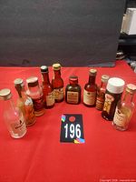 All 10 miniature bottles front view with lot tag