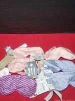Six tagged Zara Home sleep masks in assorted colors and pattern on red background