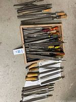 Overview of entire lot showing files and rasps in box and on floor