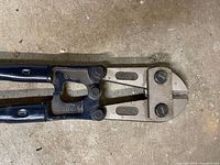 Close-up of cutting head showing 30" marking and jaw condition