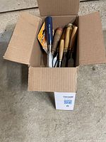 Open box with eight chisels and two EZ Mark Butt Gage packages