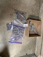 Overview of three bags and box filled with chrome wrenches