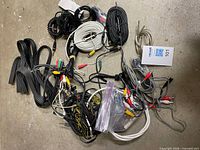 Top view of assorted cords and wires spread on floor, showing variety of cable types and connectors