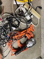 Pile of assorted cords, power strips and work light