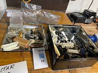 Overview of both trays with assorted guitar parts on workbench
