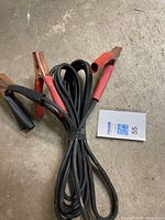 Jumper cables coiled, showing both clamps and insulation