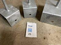 Three galvanized steel square boxes with welded rebar rods on concrete floor