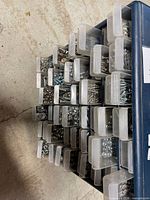 Angle view of open drawers showing assorted screws, nuts, bolts, washers