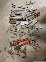 Overhead view showing complete assortment of wrenches and locking pliers on floor