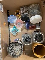 Box with multiple jars and containers of nails