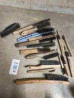 All wire brushes laid out on floor