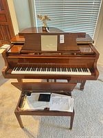 Front view of Kawai baby grand piano and bench